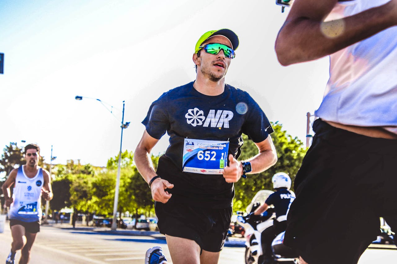 Dynamic capture of marathon runners competing outdoors on a sunny day.